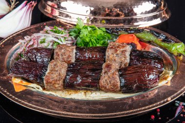 Traditional Turkish kebabs. Eggplant kebab, Adana kebab. With tomatoes, peppers, garlic, bulgur pilaf and herbs.Turkish name; patlican kebab, adana kebab.