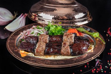 Traditional Turkish kebabs. Eggplant kebab, Adana kebab. With tomatoes, peppers, garlic, bulgur pilaf and herbs.Turkish name; patlican kebab, adana kebab.