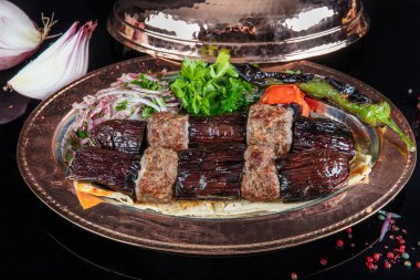 Traditional Turkish kebabs. Eggplant kebab, Adana kebab. With tomatoes, peppers, garlic, bulgur pilaf and herbs.Turkish name; patlican kebab, adana kebab.