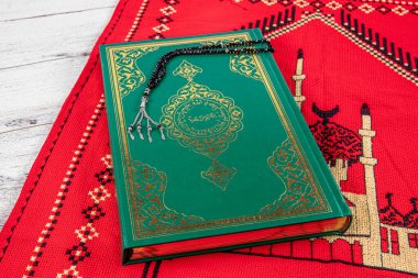 Istanbul Turkey 11 February 2022; Quran and tasbih on prayer rug. Islamic concept, The holy Quran on a praying matt . 