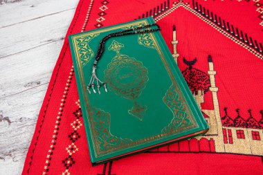 Istanbul Turkey 11 February 2022; Quran and tasbih on prayer rug. Islamic concept, The holy Quran on a praying matt . 
