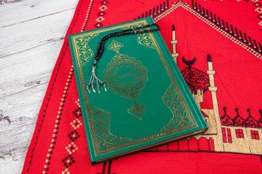 Istanbul Turkey 11 February 2022; Quran and tasbih on prayer rug. Islamic concept, The holy Quran on a praying matt . 