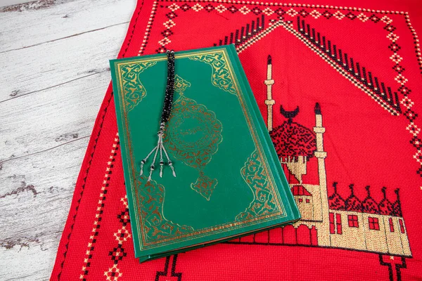 Istanbul Turkey 11 February 2022; Quran and tasbih on prayer rug. Islamic concept, The holy Quran on a praying matt . 