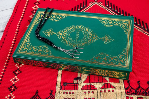 Istanbul Turkey 11 February 2022; Quran and tasbih on prayer rug. Islamic concept, The holy Quran on a praying matt . 