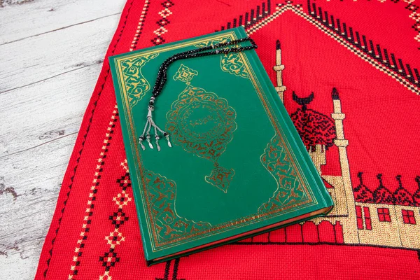Istanbul Turkey 11 February 2022; Quran and tasbih on prayer rug. Islamic concept, The holy Quran on a praying matt . 