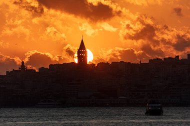 Galata Tower on a cloudy day. Galata Tower after sunset in Istanbul Turkey.
