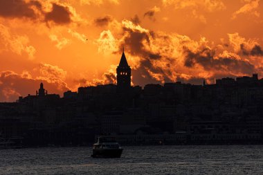 Galata Tower on a cloudy day. Galata Tower after sunset in Istanbul Turkey.