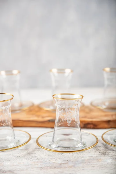 Gold gilded tea glasses. Turkish tea glass on white background.