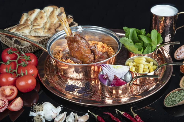 Traditional Turkish Food Lamb shank and rice. Slow cooked lamb shank. Lamb shank served on a Copper tray and in a Copper bowl.