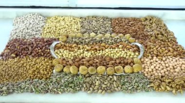 Kamera fındık makro çekim üzerinden hareket ediyor. Çeşitli fındıklar yaklaşıyor. ceviz, badem, fındık ve diğer fındıklar masada kurutulur. Yüksek kalorili vejetaryen yemeği. Kuru fındık. 4K Video.