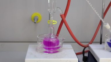 Renkli solüsyonu manyetik karıştırıcı ile karıştırıyorum. Kimyasal reaksiyon oluşumu. Video.