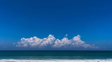 Ufukta mavi gökyüzü olan dramatik beyaz bulutlar.