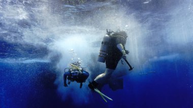 Underwater photo of scuba divers in action