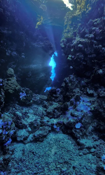 Underwater photo from a scuba dive in a cave with rays of light