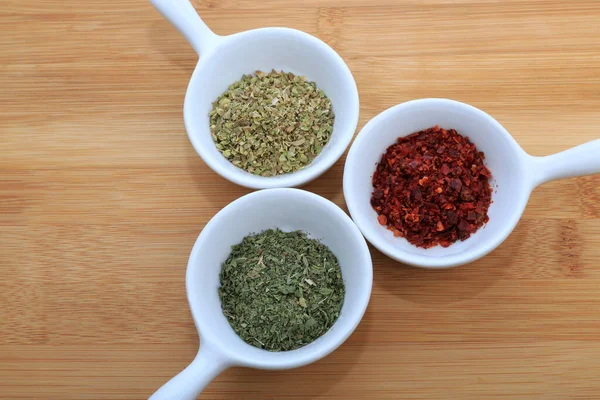 Spices in tiny bowls. Mint, Cayenne Pepper and Thyme.