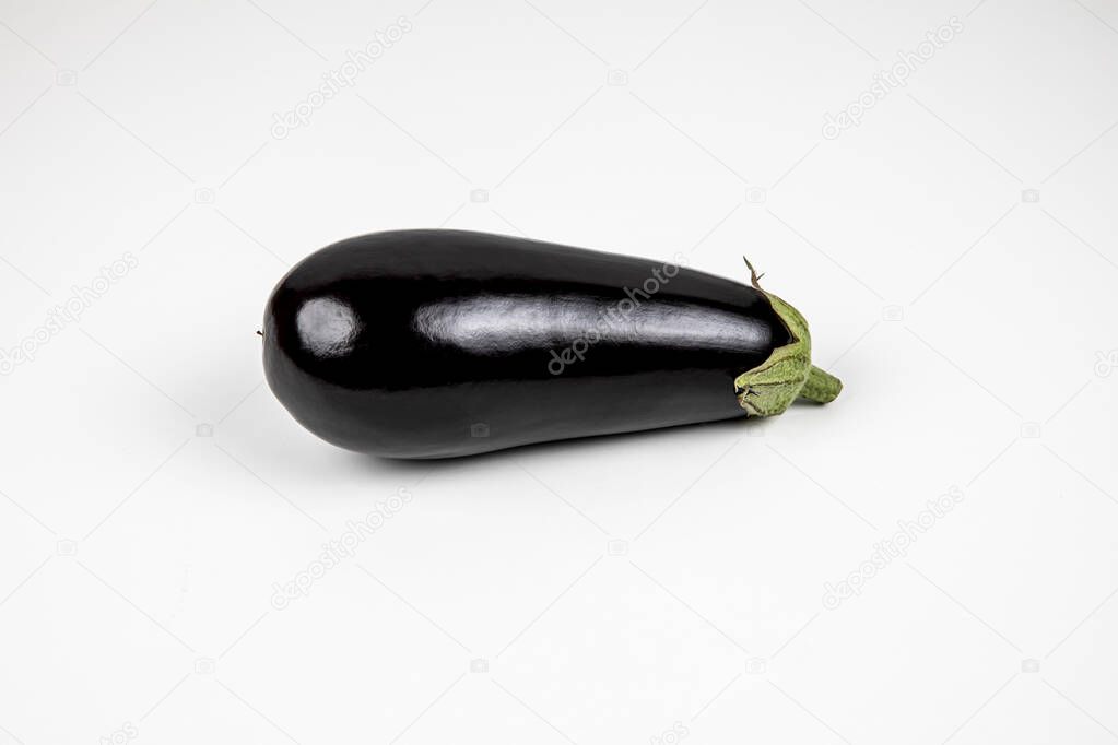 Product photography. Black eggplant on a white background. Fresh vegetables .