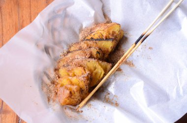 Delicious grilled pineapple slices with a sprinkling of chili powder