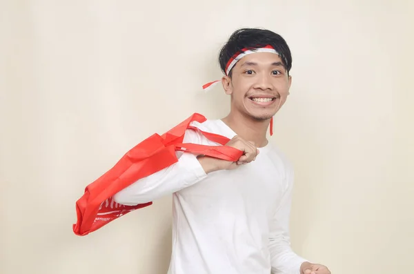 Young Man Wearing Ribbon His Head Holding Shopping Bags Isolated — Stok Foto