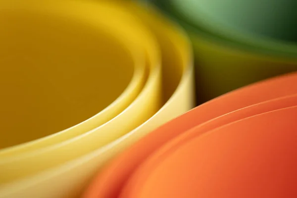 abstract vibrant color curve background, creative graphic wallpaper with orange, yellow and green for presentation, concept of dynamic movement and space, bending plastic sheets, selective focus