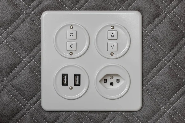 Universal wall light switch and power socket. Set of Europe socket and usb charger on cushion wall panel.