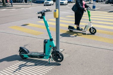 TIER electric scooter and LIME electric scooter in Zurich city, shared e-scooters are used for short commutes and journeys or sightseeing.
