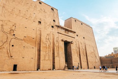 edfu, egypt. 13th october, 2021: walls of edfu temple, full of hieroglyphics in edfu city. clipart
