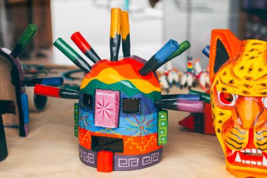 colorful ama huma masks are displayed at market stall