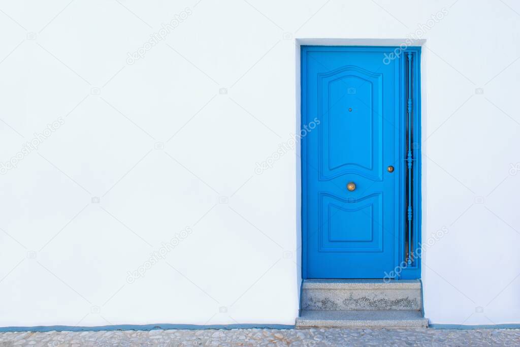 Simple blue door and pure white wall.