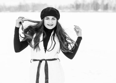 Sokakta poz veren güzel bir kadının açık hava portresi. Siyah bere takan ve örgü ören bir manken. Kadın moda konsepti