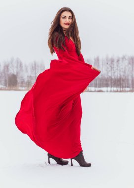 Karlı bir günde ipek elbiseyle dans eden İspanyol bir kadın, kırmızı elbisenin dalgalanması ve çırpınması, tutku konsepti