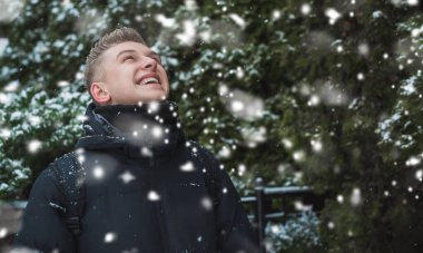 Smiling young handsome student, blonde guy, lifestyle of teen life. Portrait at winter