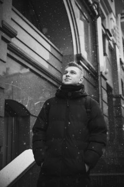 Portrait of young blonde guy Nordic appearance, lifestyle of young people. Handsome guy close up, winter day thinking about something