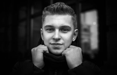 Portrait of young blonde guy Nordic appearance, lifestyle of young people. Handsome guy close up, winter day thinking about something