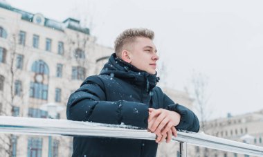 Portrait of young blonde guy Nordic appearance, lifestyle of young people. Handsome guy close up, winter day thinking about something
