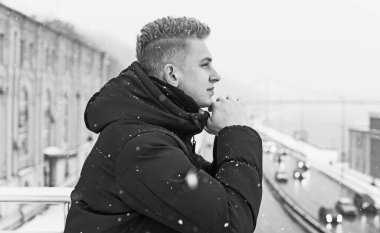 Portrait of young blonde guy Nordic appearance, lifestyle of young people. Handsome guy close up, winter day thinking about something