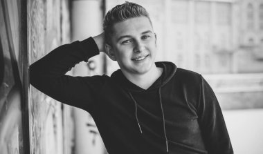 Portrait of young blonde guy Nordic appearance, lifestyle of young people. Handsome guy close up, winter day thinking about something