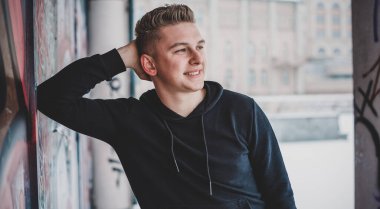 Portrait of young blonde guy Nordic appearance, lifestyle of young people. Handsome guy close up, winter day thinking about something