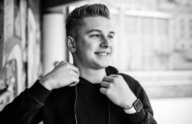 Portrait of young blonde guy Nordic appearance, lifestyle of young people. Handsome guy close up, winter day thinking about something
