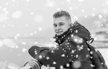Portrait of young blonde guy Nordic appearance, lifestyle of young people. Handsome guy close up, winter day thinking about something