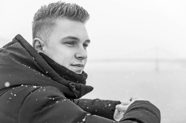 Portrait of young blonde guy Nordic appearance, lifestyle of young people. Handsome guy close up, winter day thinking about something