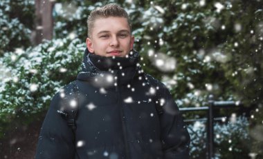 Portrait of young blonde guy Nordic appearance, lifestyle of young people. Handsome guy close up, winter day thinking about something