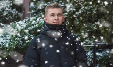 Portrait of young blonde guy Nordic appearance, lifestyle of young people. Handsome guy close up, winter day thinking about something