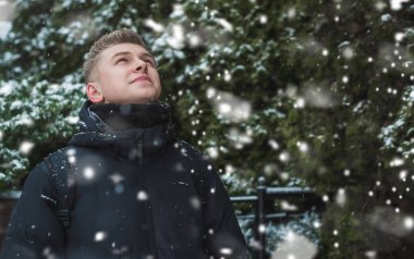 Portrait of young blonde guy Nordic appearance, lifestyle of young people. Handsome guy close up, winter day thinking about something