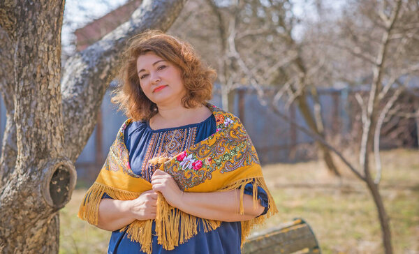 European Plus size ethnic woman in embroidery traditional shirt and scarf. Concept of national costume. Eastern Europe traditional style
