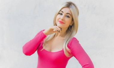 Klasik kız pembe tonlu Barbie bebeğe benziyor. Sarışın kadın makyaj malzemesi pembe kazak giyer, şık bir konsept.