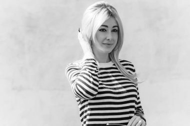  60 'lar-70' ler görünüşü. Sarışın kadın makyaj malzemesi çizgili kazak, modaya uygun bir konsept.