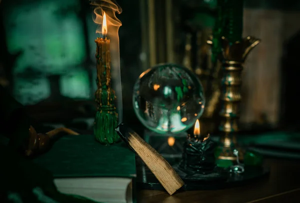魔法のようなもののイラスト キャンドルライト クリスタルボール 魔法の杖 呪文の本暗い背景 スリザリン学校 緑の美学 ハロウィーンの時間 — ストック写真