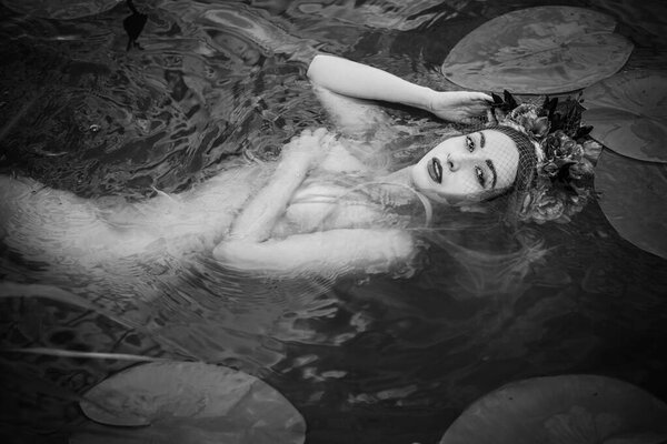 Old European magic, Mystical Pagan scene, woman in lake, rite. Magic divination in water, undina