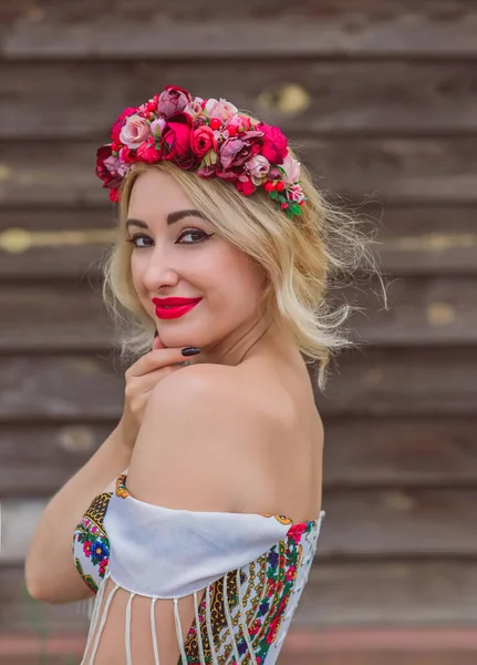 Woman in Slavic ethnic embroidered dress, flower wreath in hair. Concept of beauty Slavic women, Boho style