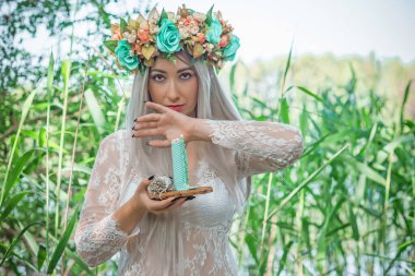 Eski Avrupa büyüsü, Gizemli Pagan sahnesi, gölde mumları olan kadın, ayin. Suda sihirli kehanet